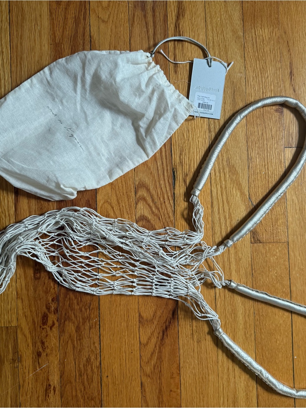 The Need Supply Net Bag in White/Metallic handles